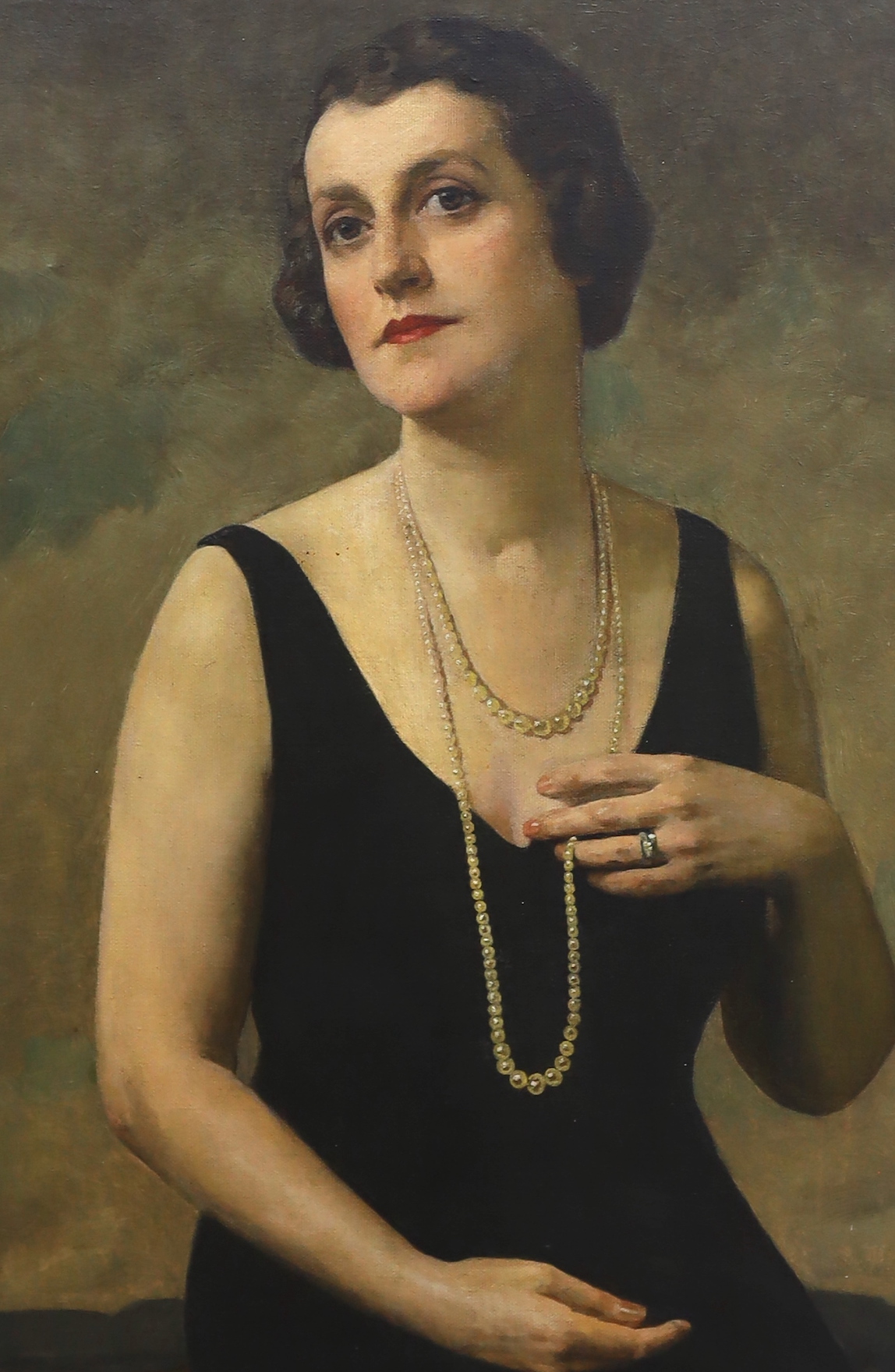 In the manner of Oswald Birley (1880-1952), early 20th century oil on canvas, Half length portrait of an Art Deco woman, unsigned, 75 x 49cm